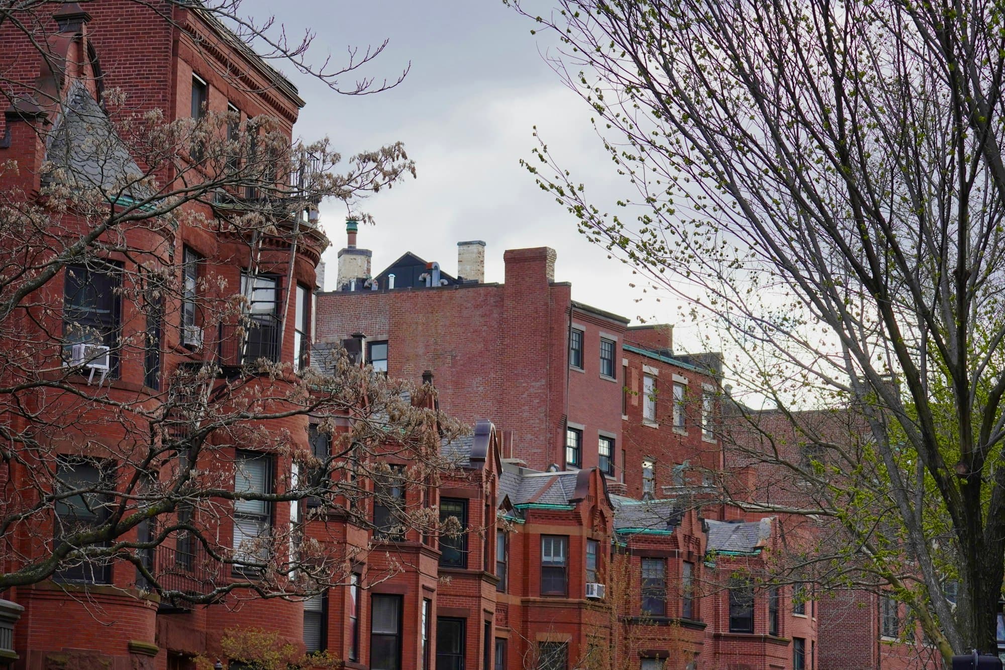 A row of historic red brick Boston rowhouses