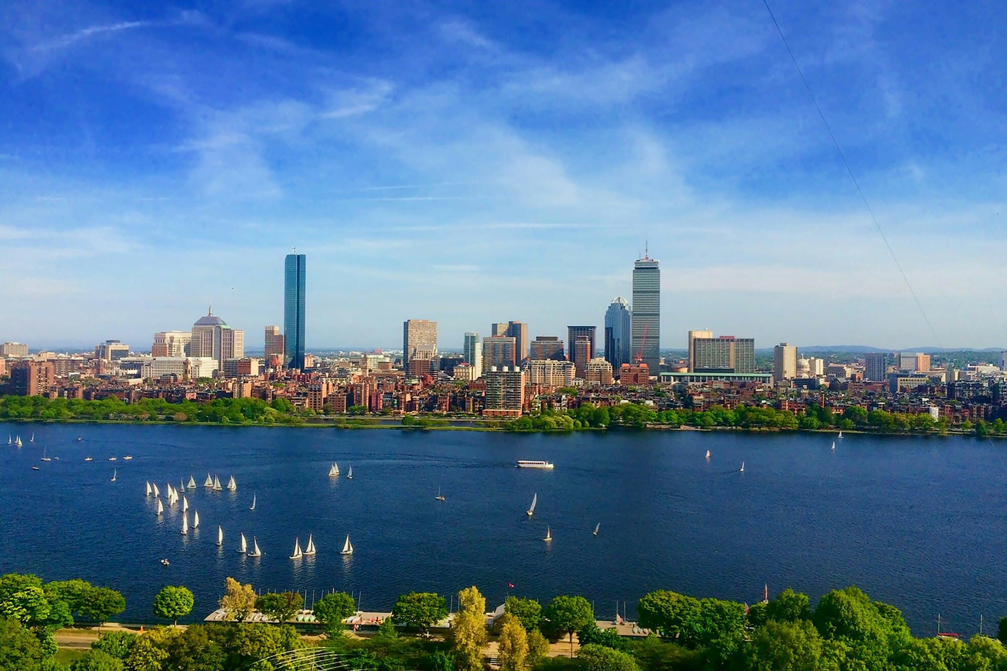 The Boston skyline across the Charles River on a sunny day