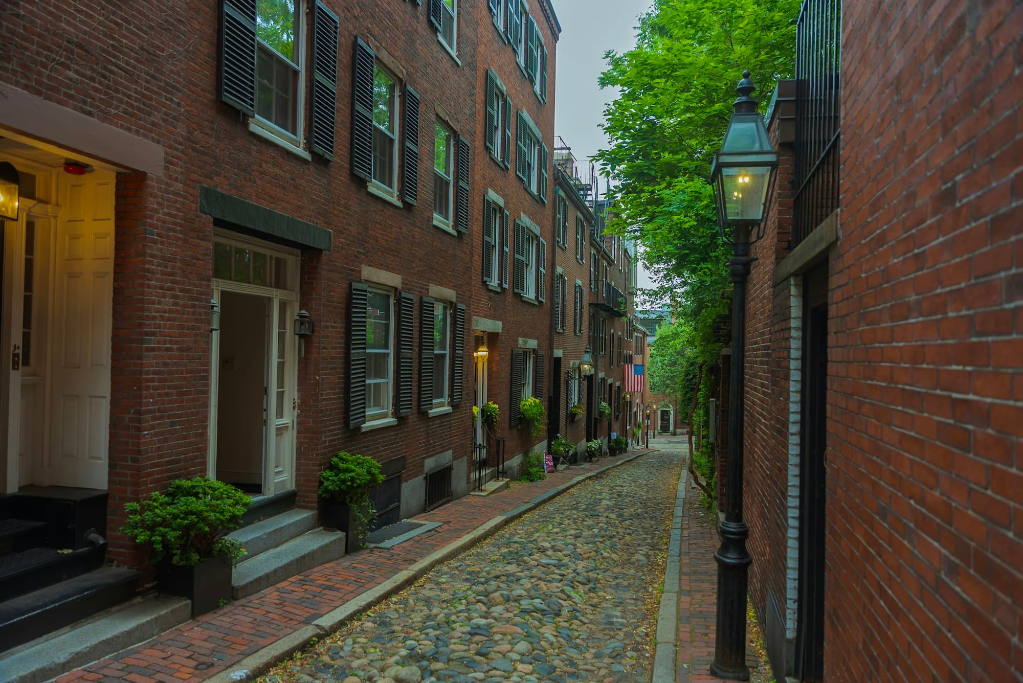 Cobblestone Boston street lined with brick homes